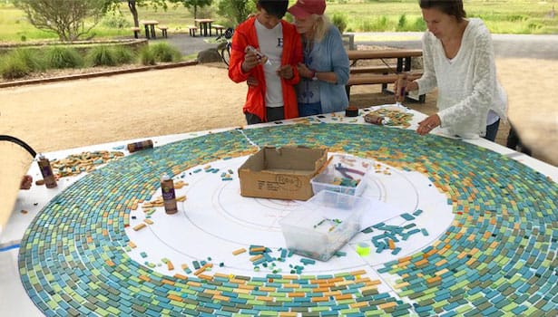 Community volunteers creating the labyrinth mosaic