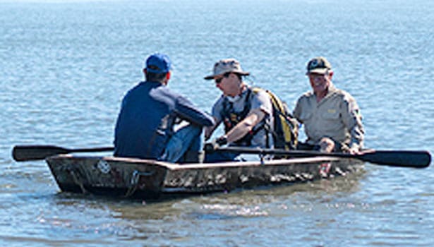 Parks staff and volunteers in the rowboat to Kent Island