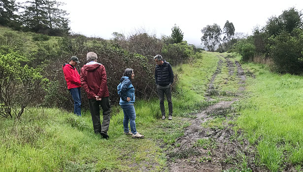 Community group on site reviewing wet conditions at School Trail